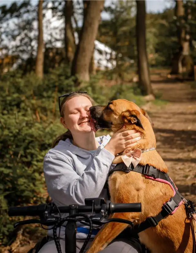 Dee from Oreo's Way Dog Training in Middlesbrough getting a kiss from a dog